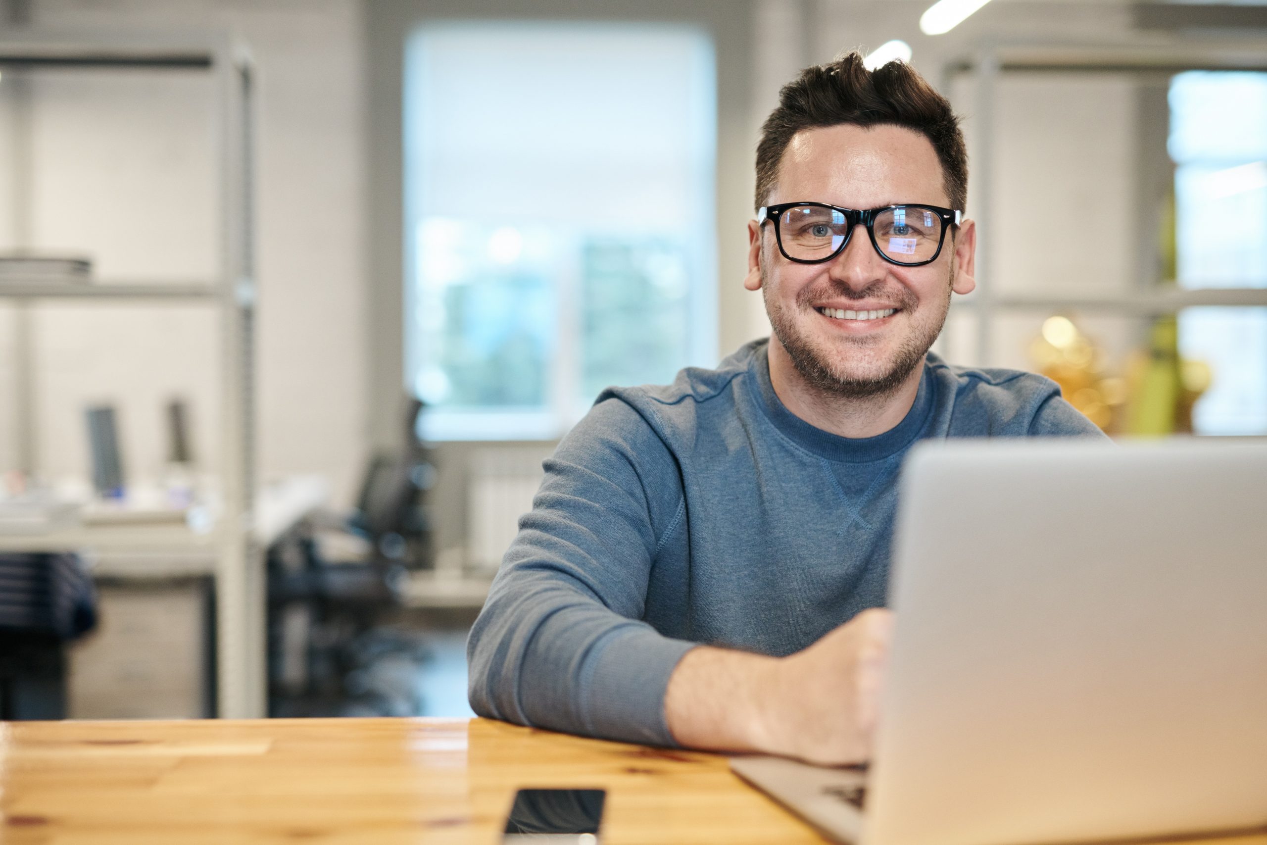 photo-of-man-wearing-eyeglasses-3184611 a man sitting in front of a computer searching for a job
