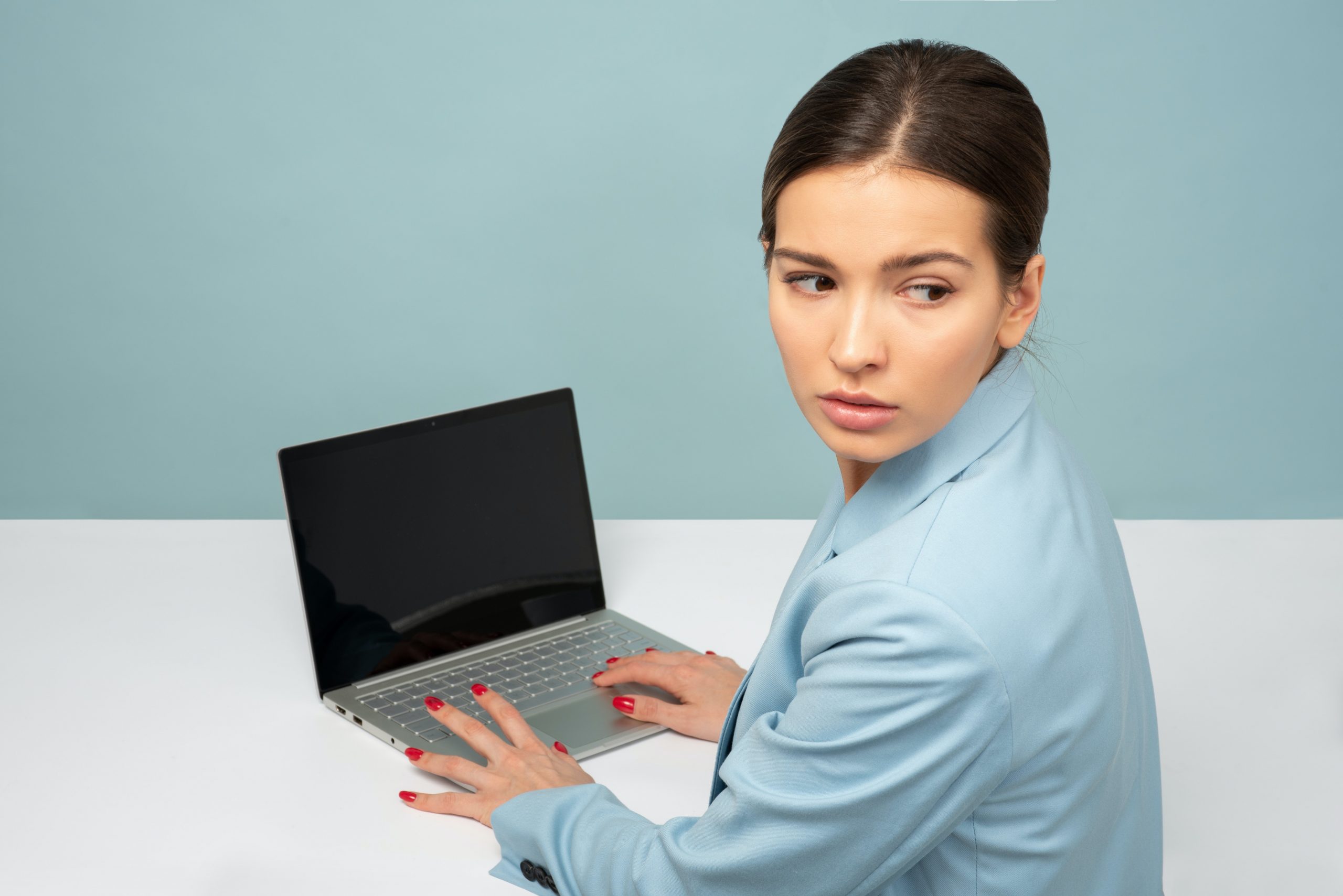 woman-holding-laptop-computer-while-facing-backward-1587043