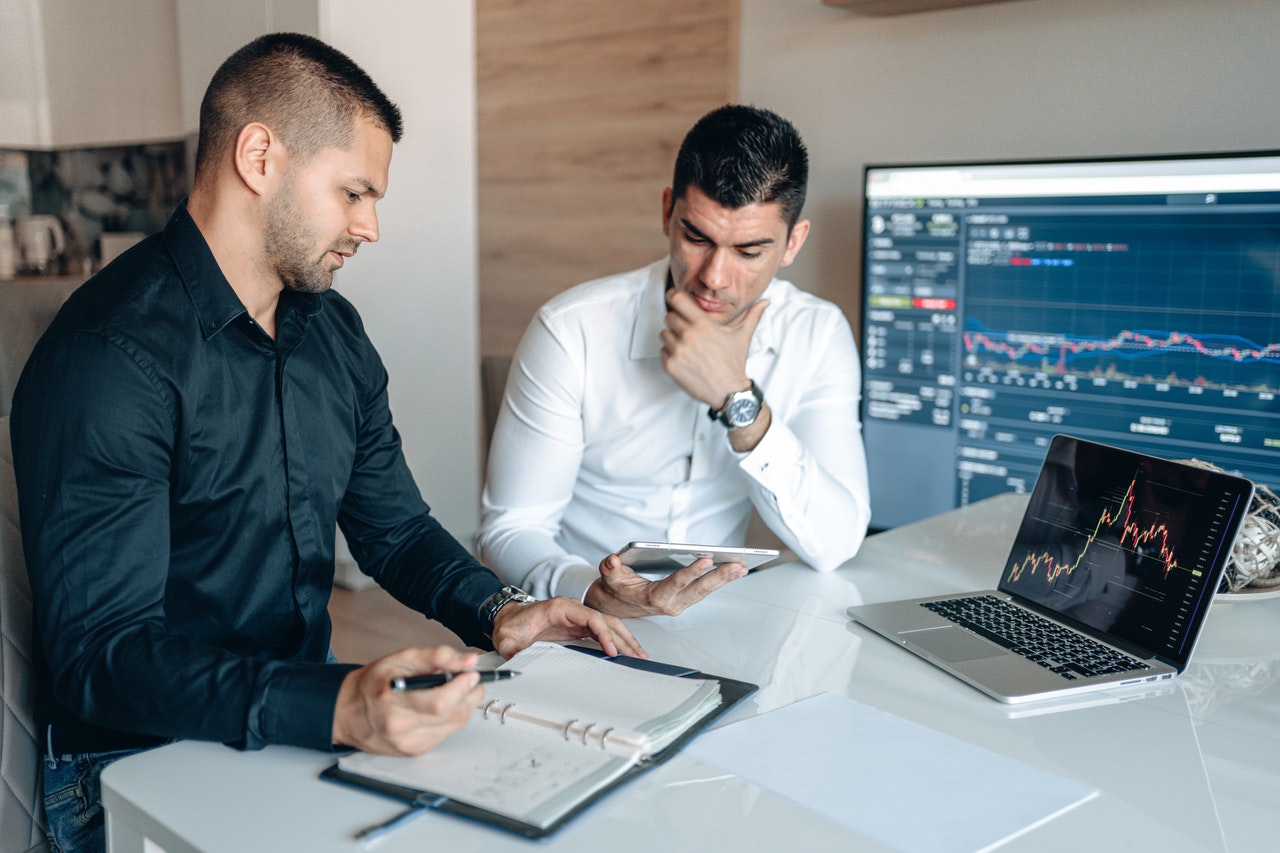 two guys in an office discussing work placements