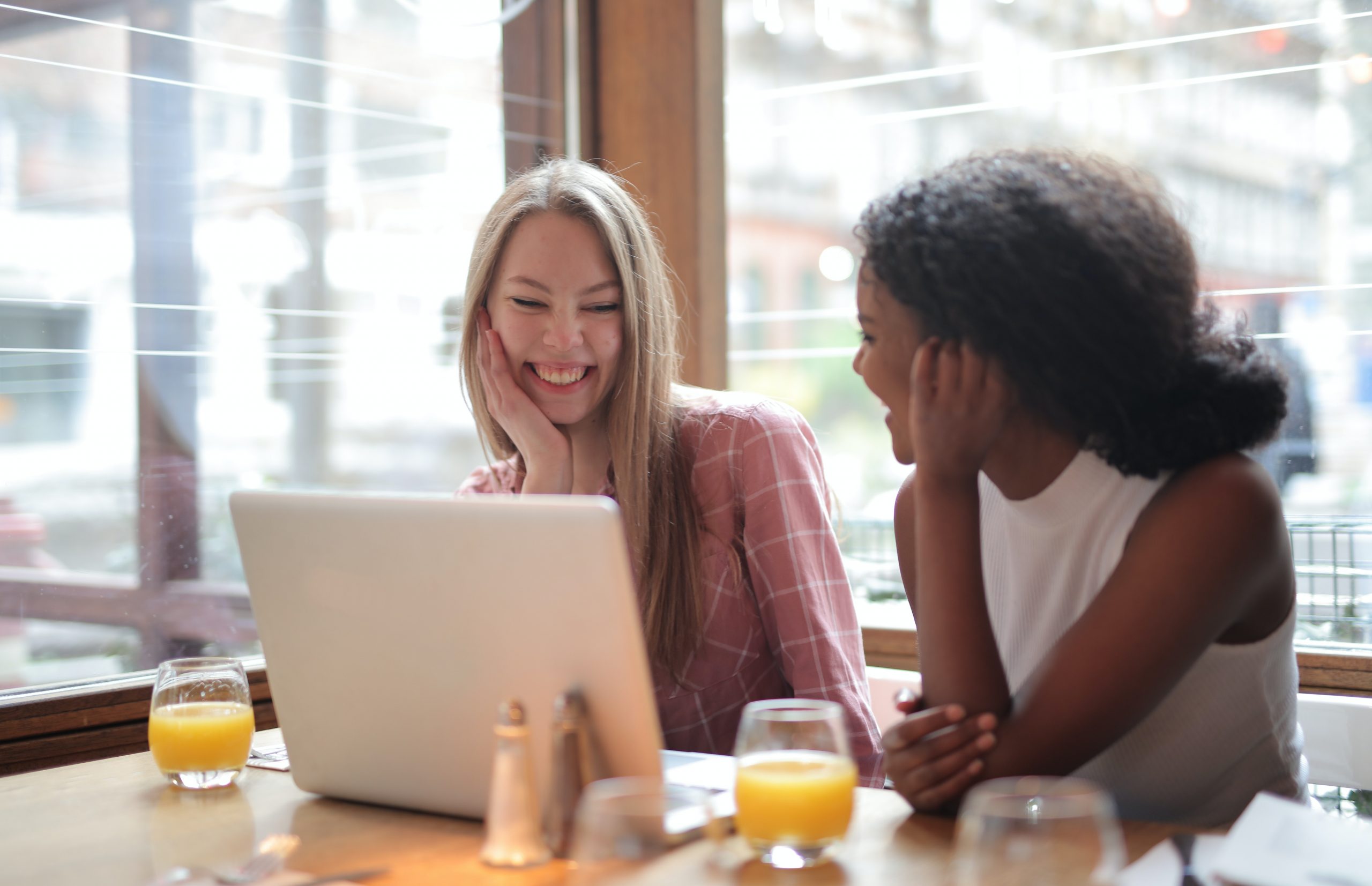 two girls sitting in front of a computer