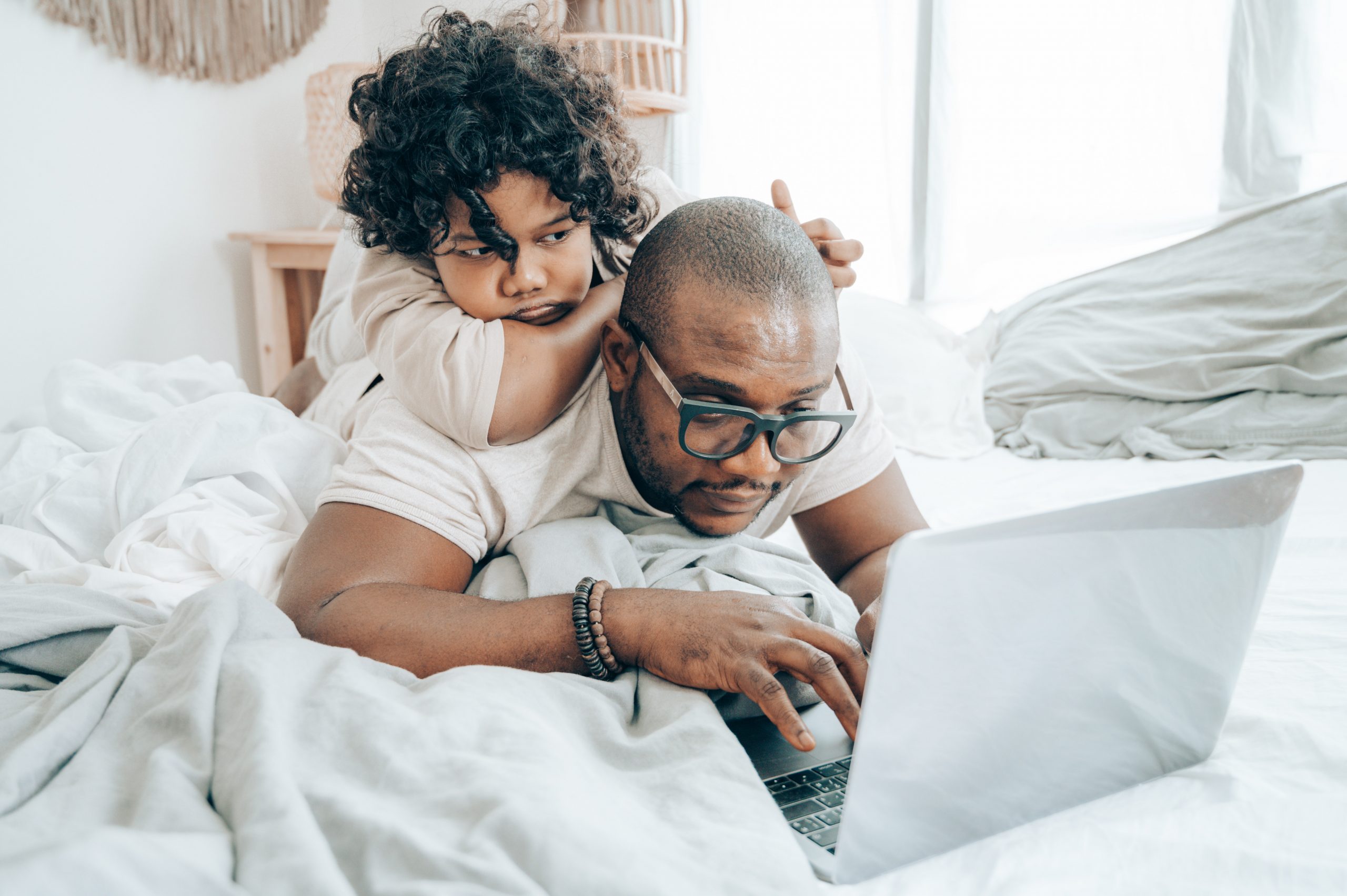 Work-life balance a daughter and father in front of a laptop
