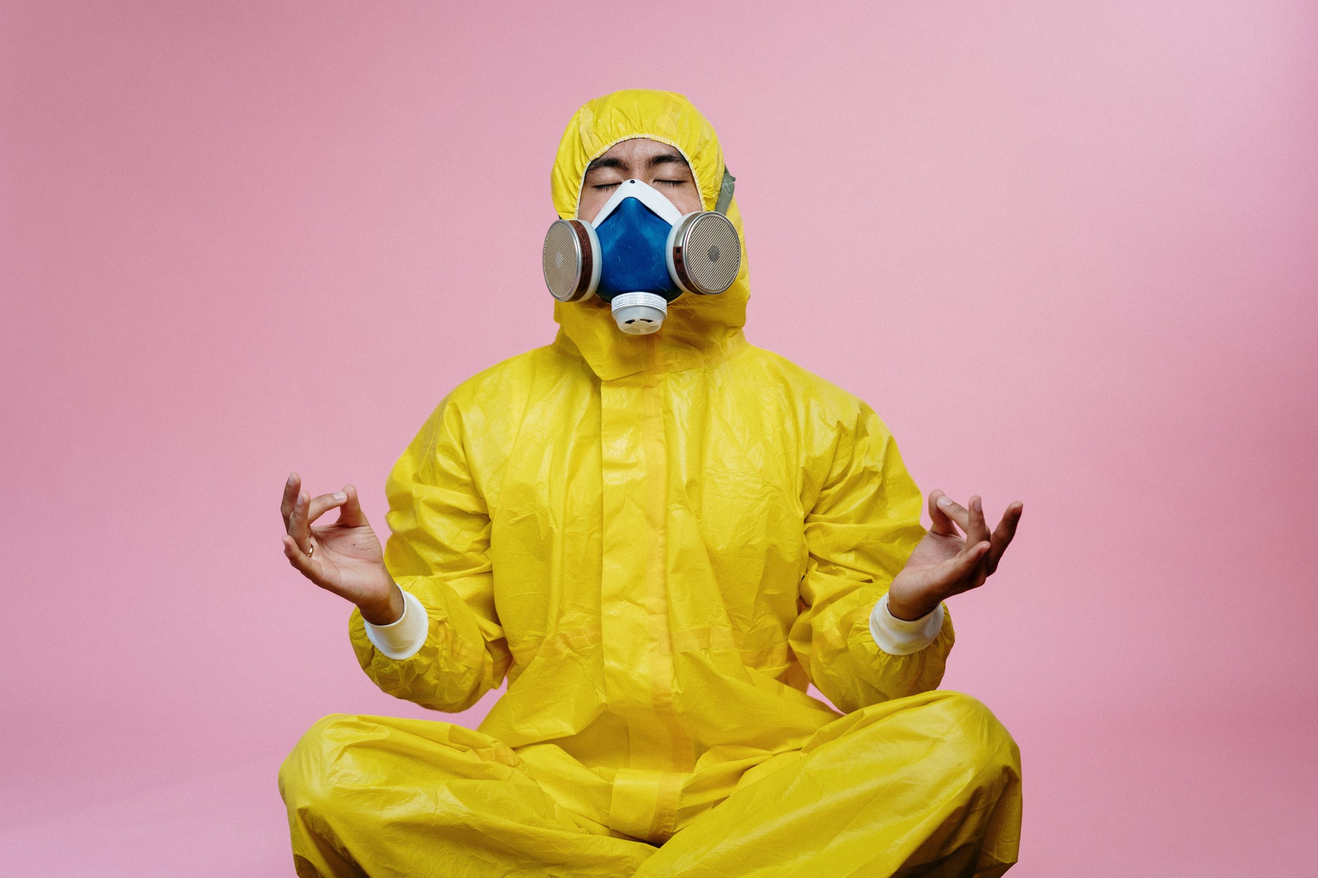 a man wearing protective suit and a gas mask